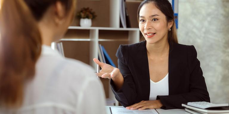 two businesswomen at a desk