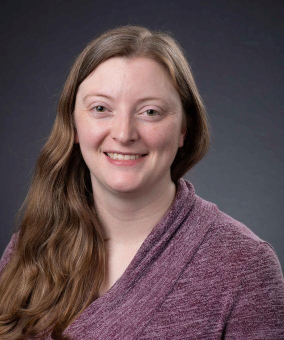 Woman with long hair and purple top
