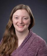 Woman with long hair and purple top